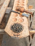 Mancala board with carved wooden pieces